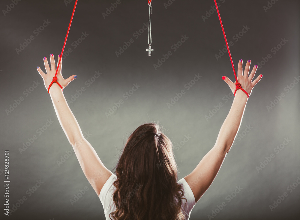 Tied woman forced to worship. Fake faith religion. Stock Photo Adobe Stock