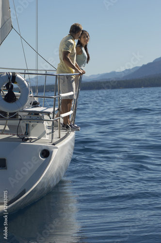 Full length of a couple travelling in a sailboat