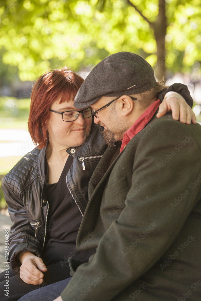 Sweden, Sodermanland, Smiling woman with down syndrome sitting next to boyfriend Sweden, Sodermanland, Smiling woman with down syndrome sitting next to boyfriend