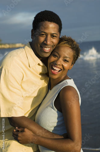 Portrait of an African American couple embracing at beach © moodboard