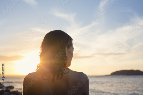 Australia, New South Wales, Botany Bay, Rear view of woman looking at sea during sunset