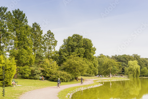 Sweden, Skane, Malmo, Kungsparken, Green trees along lake photo