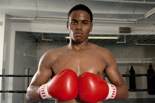 Portrait of an African American boxer wearing red gloves ready for a fight