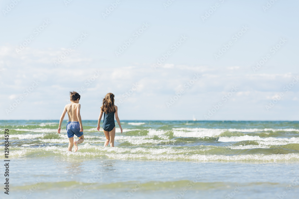Sweden, Oland, Kopingsvik, Girl (10-11) and boy (8-9) walking into sea Sweden, Oland, Kopingsvik, Girl (10-11) and boy (8-9) walking into sea