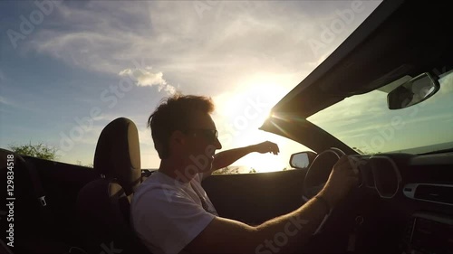 Wallpaper Mural CLOSE UP: Excited young man enjoying the beach drive in convertible at sunset Torontodigital.ca
