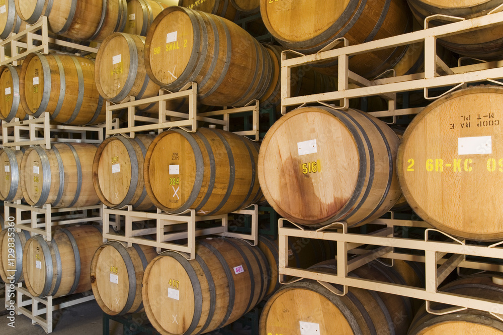 Wine barrels stacked in the cellar of the winery Wine barrels stacked in the cellar of the winery