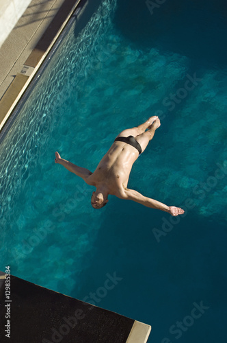 High angle view of a man diving in midair into the pool