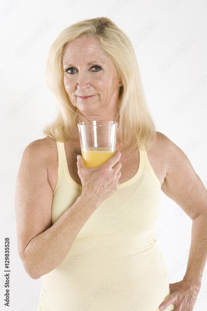 Portrait of a beautiful mature woman enjoying a glass of orange juice Portrait of a beautiful mature woman enjoying a glass of orange juice