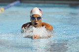 Front view of a Caucasian swimmer in motion during swimming race
