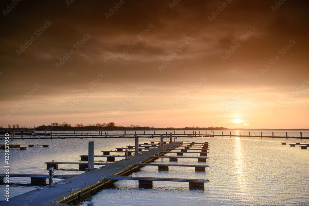 Yacht port over orange sunset