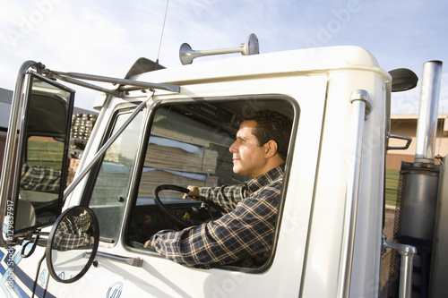 Portrait of mature male worker driving truck © moodboard