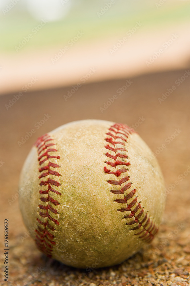 Baseball laying in the base path on a baseball field