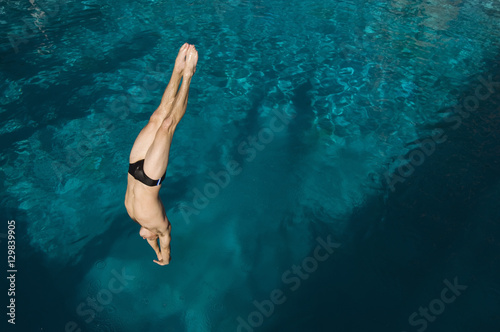 Canvas-taulu High angle view of a man diving into the pool