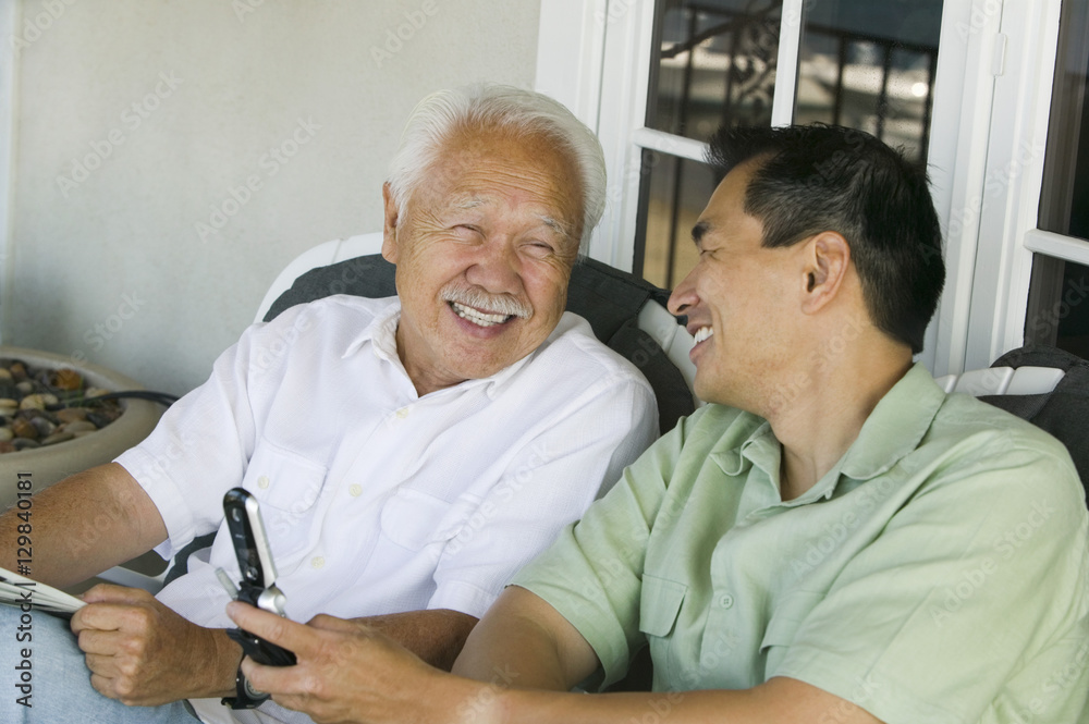 Obraz premium Father and son laughing outside home