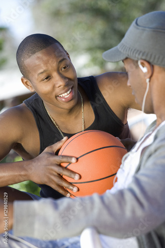 Two African American young men talking to each other