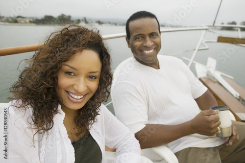 Portrait of a happy African American couple relaxing on the yacht