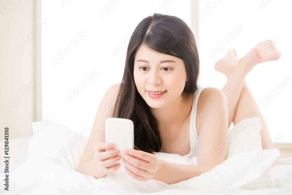 relaxed asian woman use smart phone reading text message