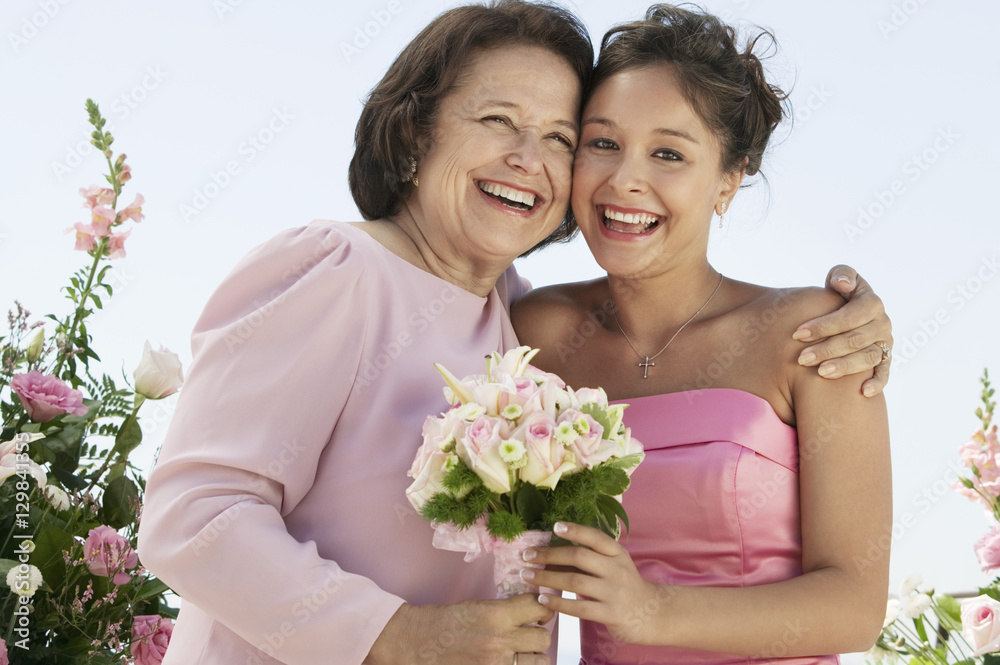 Mother and Bride with bouquet outdoors (portrait)