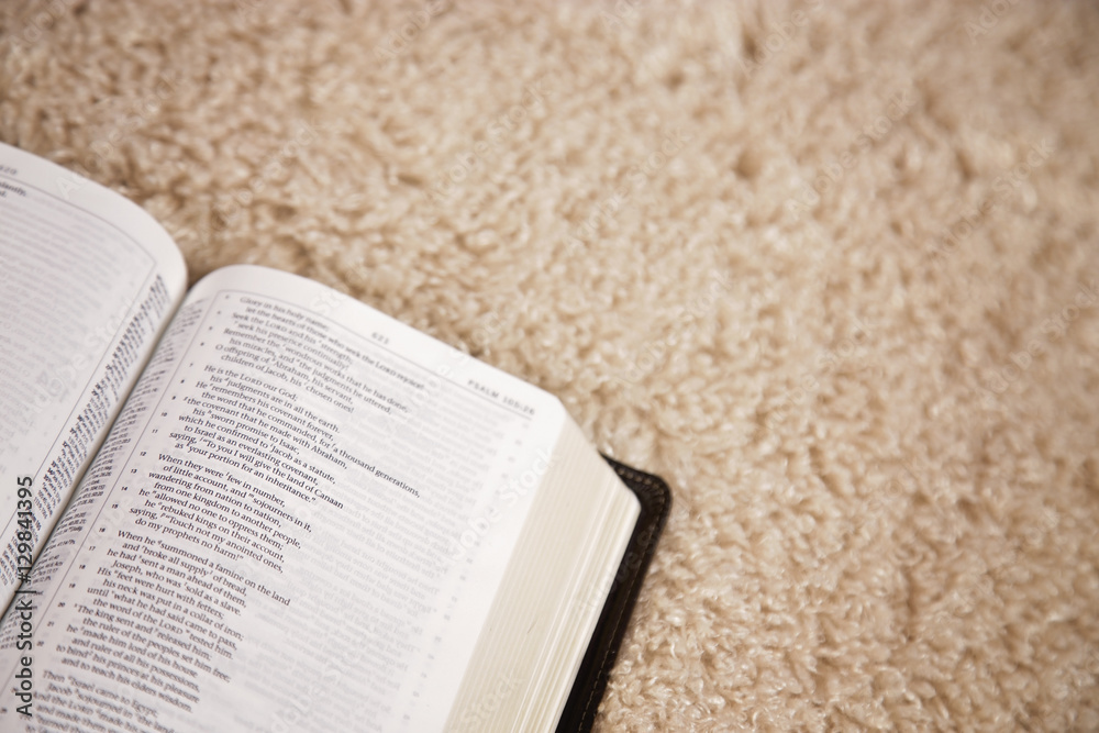 Fototapeta premium Opened Bible on Carpet