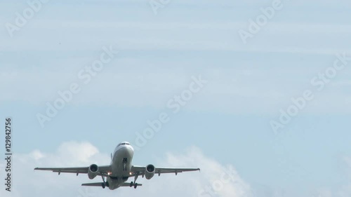 Airplane departing from Portland International Airport, flying overhead.