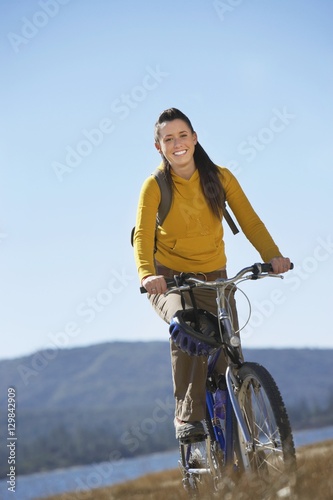 Portrait of happy female riding bicycle