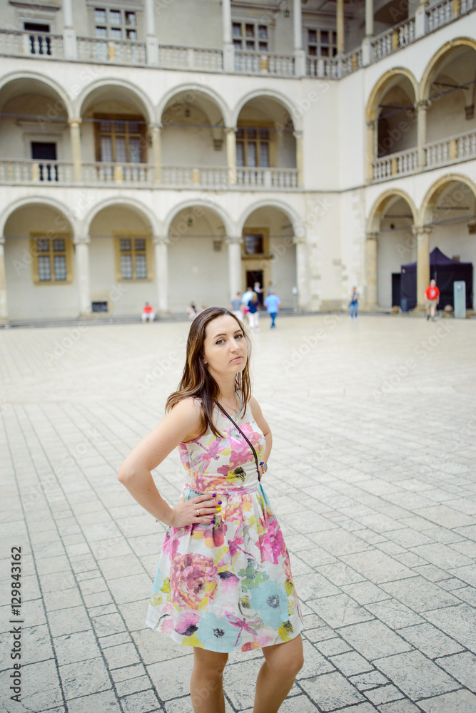 Naklejka premium Beautiful girl during sightseeing old castle in Cracow, Wawel.