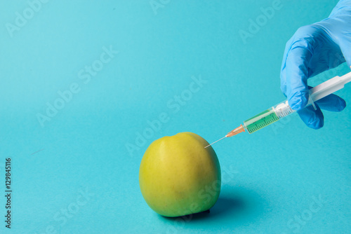 Chemical additives in food or genetically modified fruit concept.