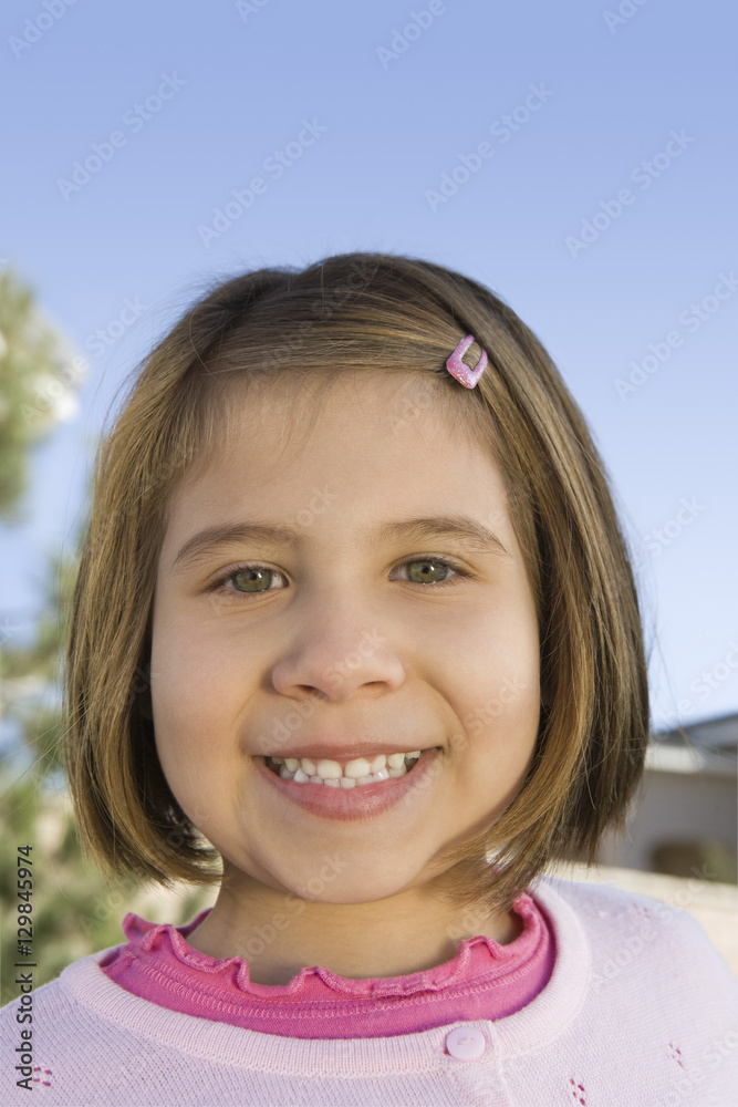 Close-up portrait of happy girl smiling against sky Close-up portrait of happy girl smiling against sky