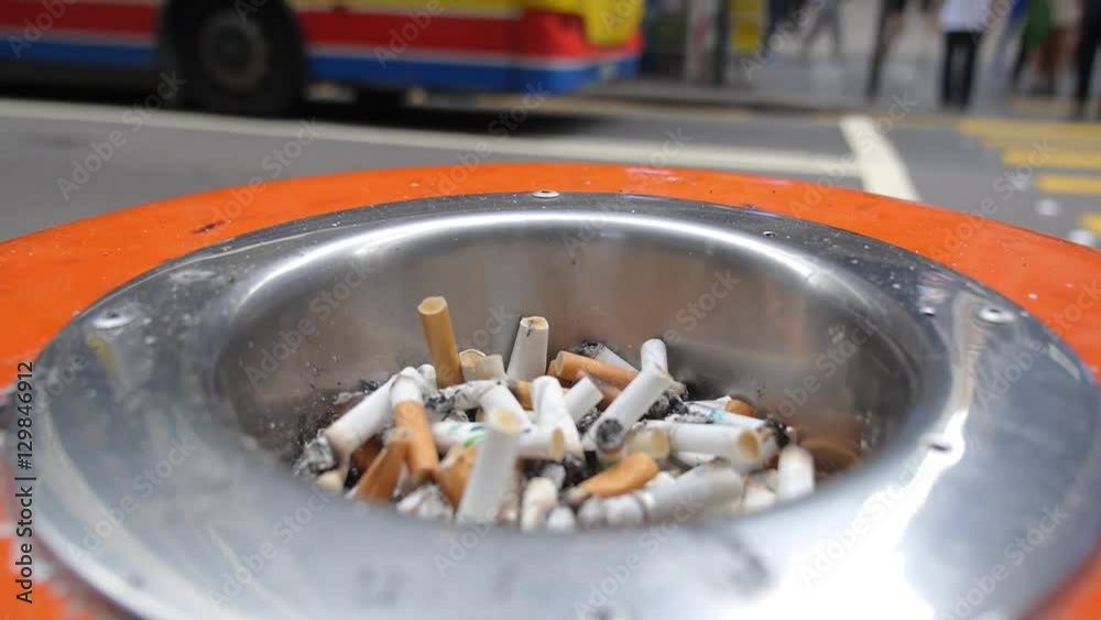 Public Ashtray Full of Cigarette Ends or Butt on City Street Public Ashtray Full of Cigarette Ends or Butt on City Street