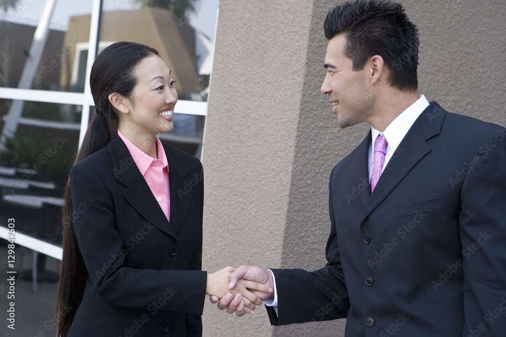 Happy Japanese business people shaking hands Happy Japanese business people shaking hands