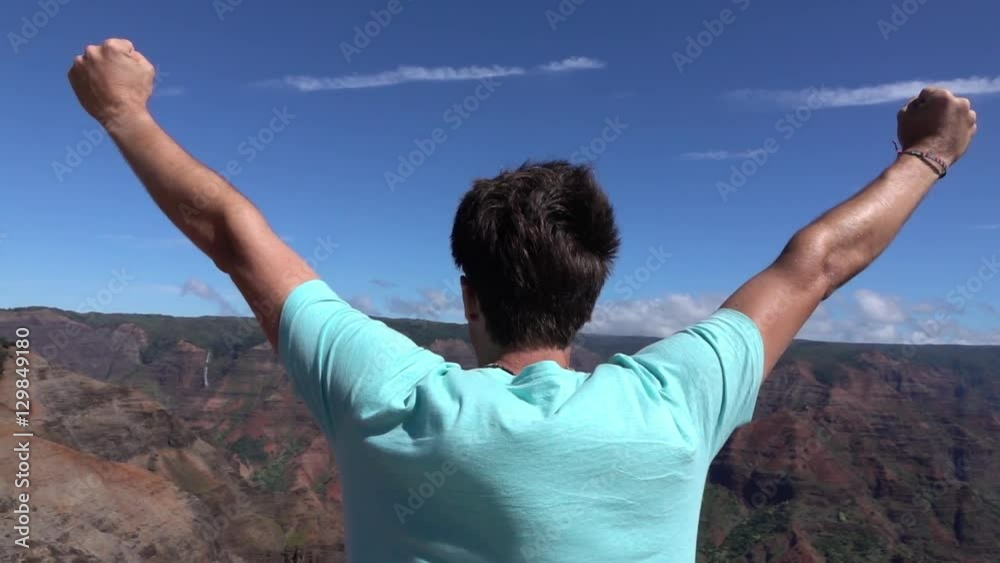 SLOW MOTION: Happy man on top of the mountain outstretching arms victoriously SLOW MOTION: Happy man on top of the mountain outstretching arms victoriously