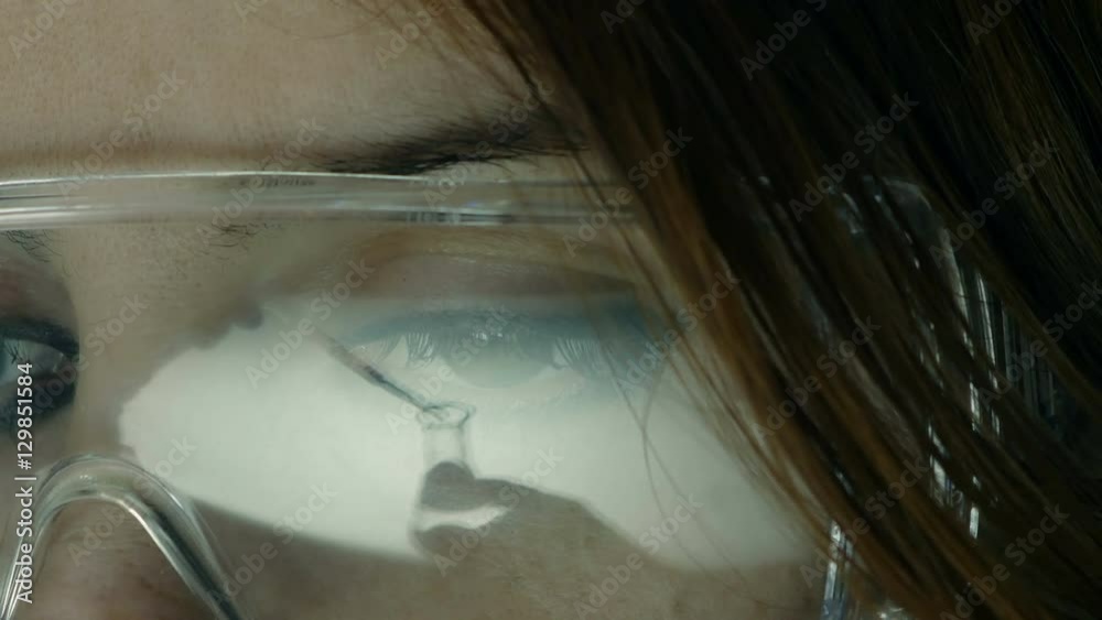portrait of a young woman researcher with safety glasses