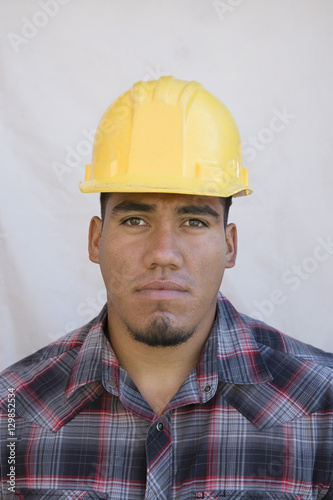 Portrait of a man wearing hardhat isolated on white background