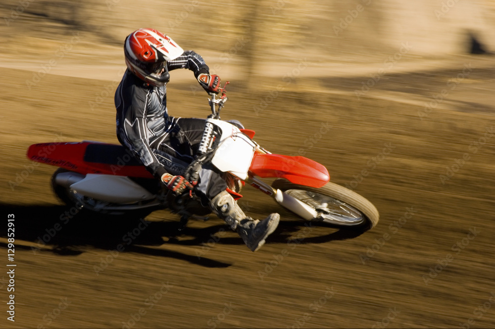Φωτογραφία Male off road biker riding the motor bike with speed on a race track
