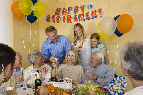 Canvas Print Happy senior couple celebrating retirement party with friends and family