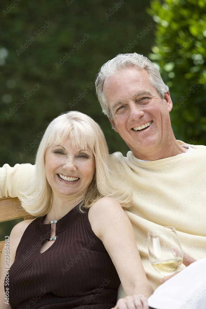 Portrait of a middle aged couple with wineglass in the garden Portrait of a middle aged couple with wineglass in the garden