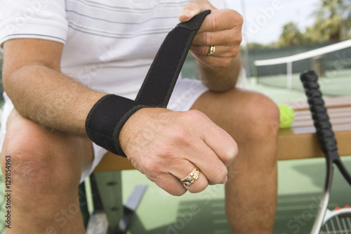Midsection of a senior male tennis player wearing wristband