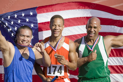 Relay team with American flag and medals