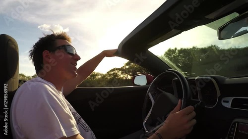 Wallpaper Mural SLOW MOTION: Excited smiling man enjoying the summer day driving in convertible Torontodigital.ca