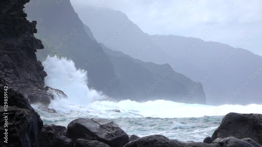 SLOW MOTION: Strong wave splashing into coarse ocean cliff upcoming from the sea SLOW MOTION: Strong wave splashing into coarse ocean cliff upcoming from the sea