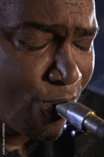 Closeup of an African American man playing saxophone