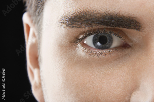 Detailed image of man with blue eye on black background