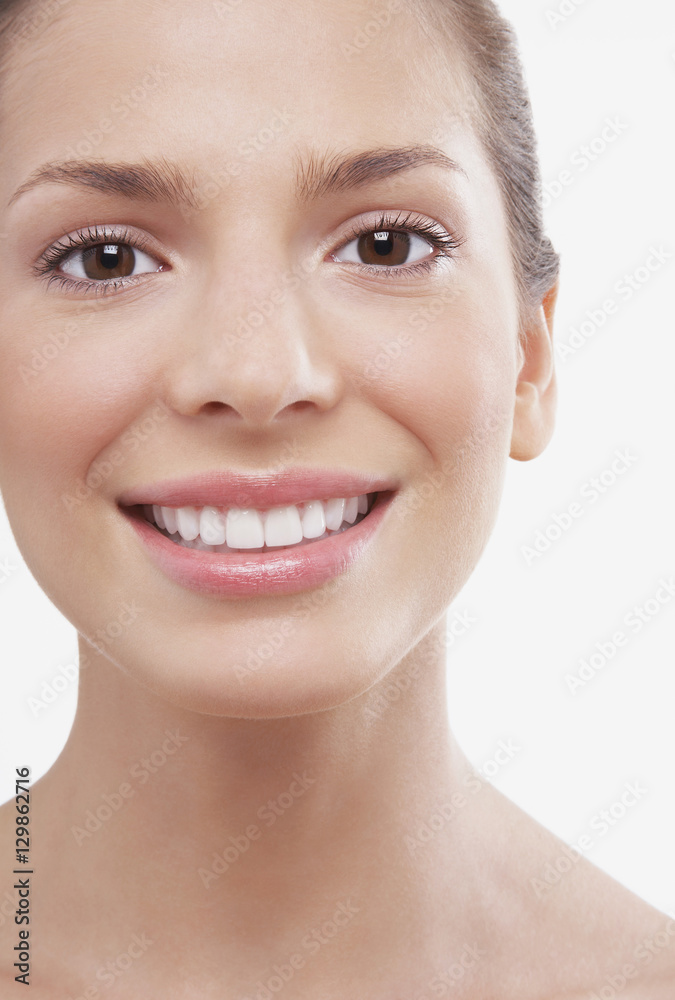Closeup portrait of beautiful young woman smiling on white background Closeup portrait of beautiful young woman smiling on white background