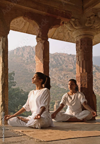 Women practising yoga in the abandoned town of Bhangarh, Alwar, Rajasthan photo