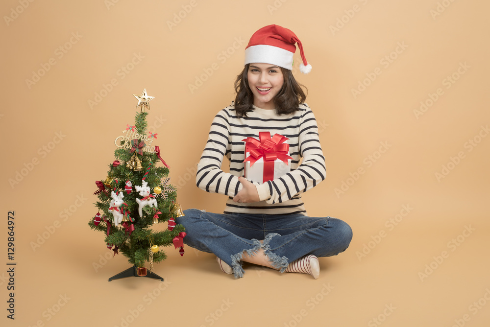 Beautiful christmas girl in santa hat with boxes on autumn back Beautiful christmas girl in santa hat with boxes on autumn back
