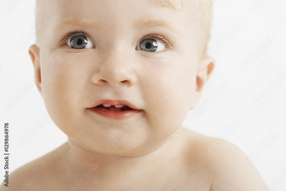 Closeup of cute baby with blue eyes isolated on white background Closeup of cute baby with blue eyes isolated on white background