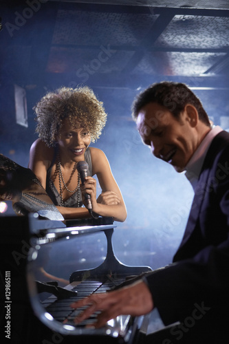 Photography Happy female jazz singer and pianist on stage