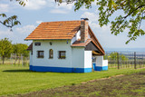 alone farm house with red roof in garden