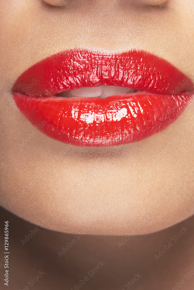 Fototapeta premium Closeup of sensuous woman wearing red lipstick
