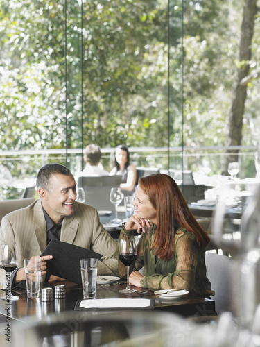 Photography Cheerful middle aged couple enjoying wine at restaurant